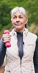 Fitness, outdoor and old woman with dumbbells, walk and physical activity for wellness and workout. Cardio, movement and happy senior person with exercise equipment, breathing and training in nature